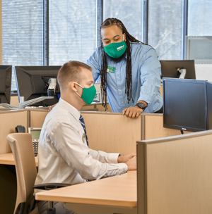 Aundre Chambers, Systems Engineer at WSFS, collaborating with a fellow Associate.