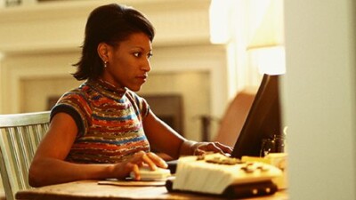 A woman using a laptop.