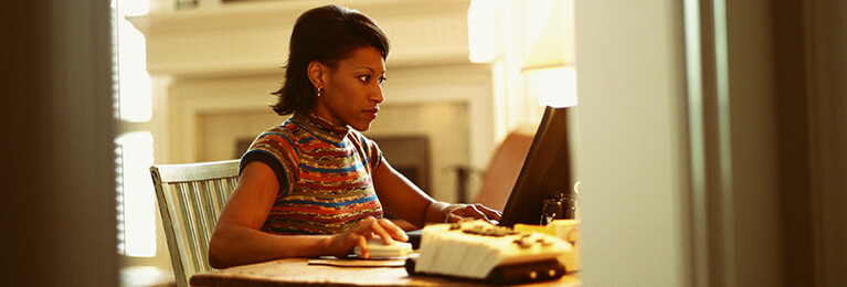 A woman using a laptop.