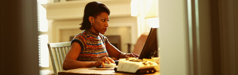 A woman using a laptop.