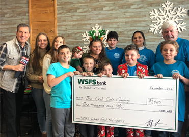 Owners and family of the Crab Cake Company accepting a donation check from WSFS.