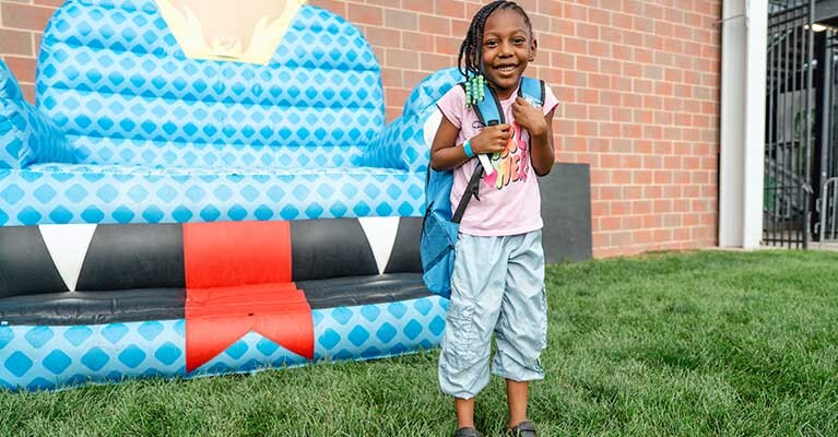 A girl with a backpack.