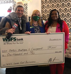 An employee from Dolly’s Boutique & Consignment holding a giant check for $1,000 along with a WSFS Associate and FOX29’s Bob Kelly.