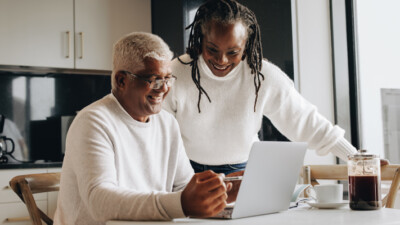 A couple using a laptop.