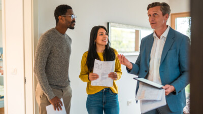 A couple searching for their new house with their real estate agent.