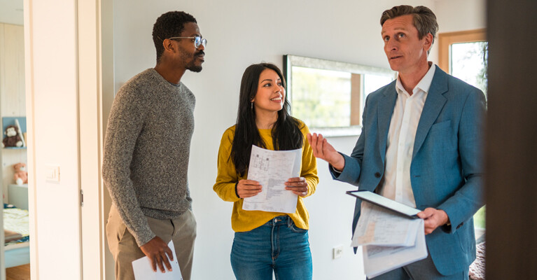 A couple searching for their new house with their real estate agent.