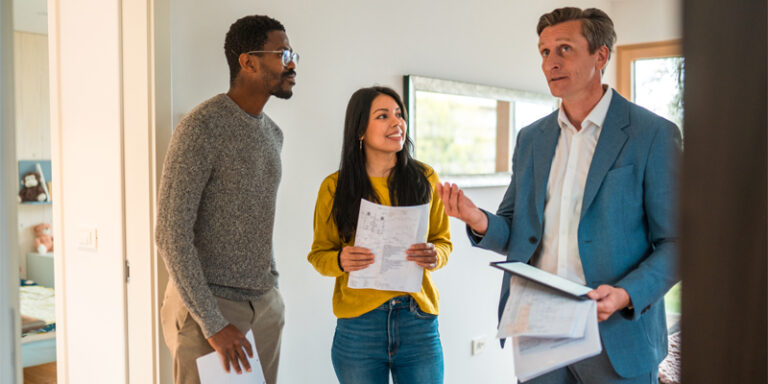 A couple searching for their new house with their real estate agent.