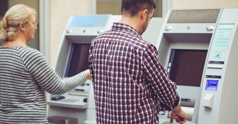 Customers using ATMs.