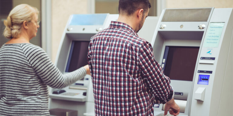 Customers using ATMs.