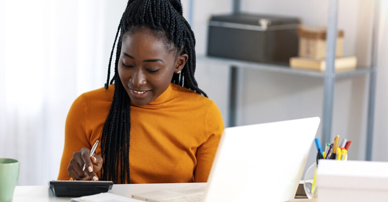 A woman doing calculations on a calculator.