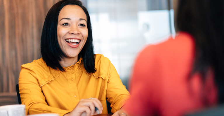 An excited woman, smiling.