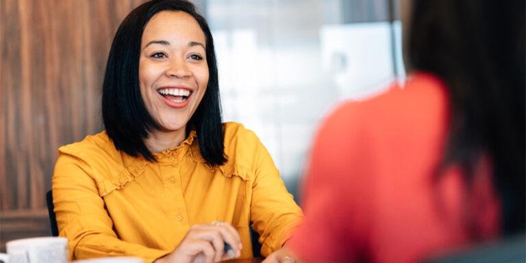 An excited woman, smiling.