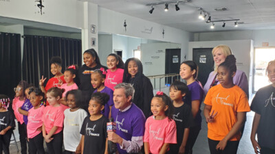 Fox 29 news anchor and WSFS Associate standing with students of Amped Dance Academy.