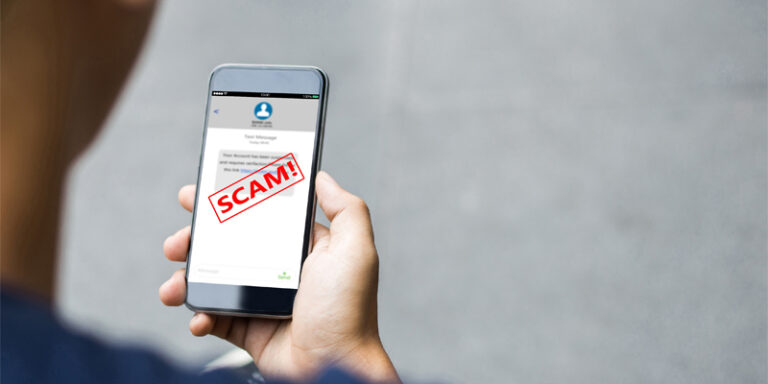 A person receiving a scam text message.