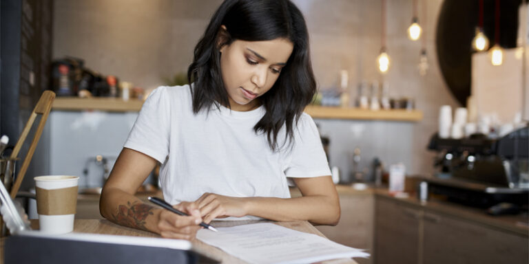 A woman filling out paperwork.