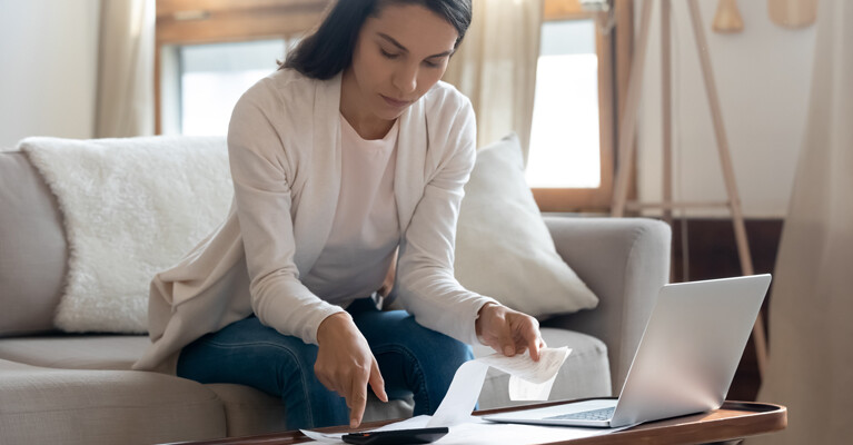 A woman reviewing receipts and her finances.