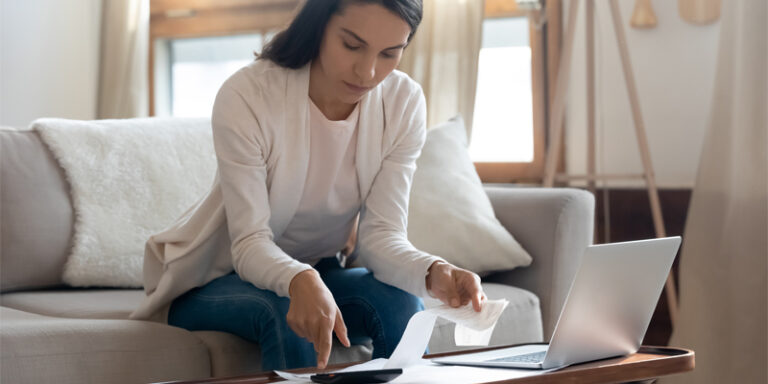 A woman reviewing receipts and her finances.