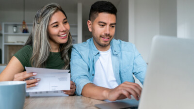 A couple paying bills online.