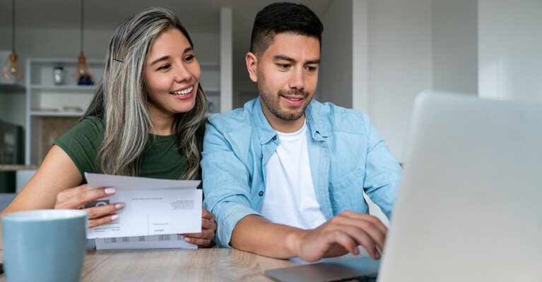 A couple paying bills online.