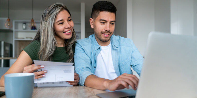 A couple paying bills online.