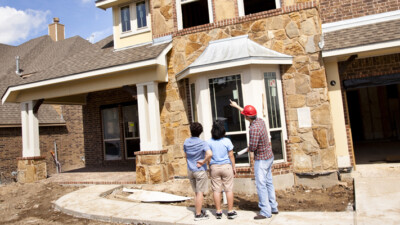 A couple talking with the construction manager for their new home.