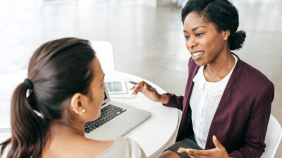 Businesswoman talking with woman.