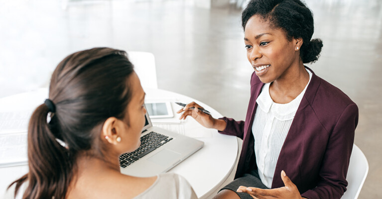 Businesswoman talking with woman.