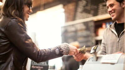 A woman paying at a cash register.