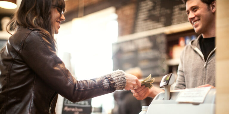 A woman paying at a cash register.