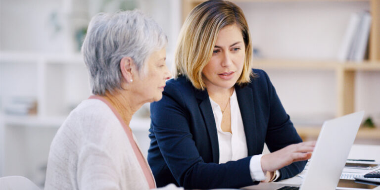A financial advisor going over paperwork with a customer.