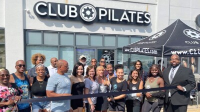 Club Pilates owners and staff at ribbon cutting ceremony.