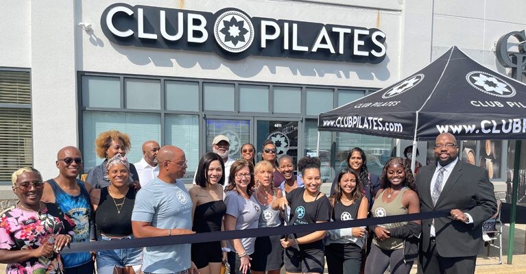Club Pilates owners and staff at ribbon cutting ceremony.