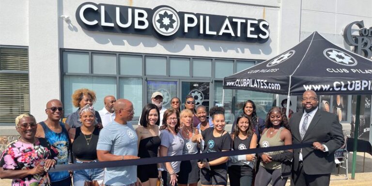 Club Pilates owners and staff at ribbon cutting ceremony.
