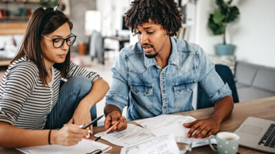 A man and a woman going over paperwork together.