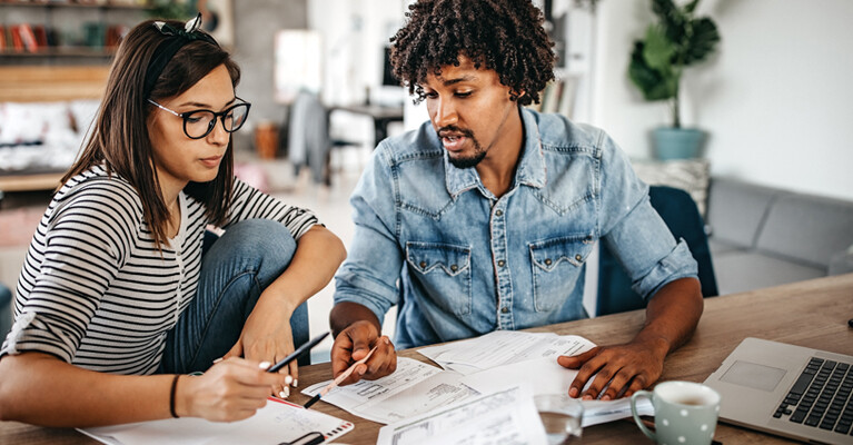 A man and a woman going over paperwork together.