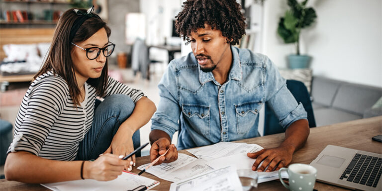 A man and a woman going over paperwork together.