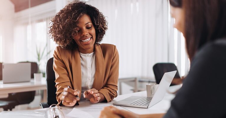 A businesswoman smiling and going over documents.