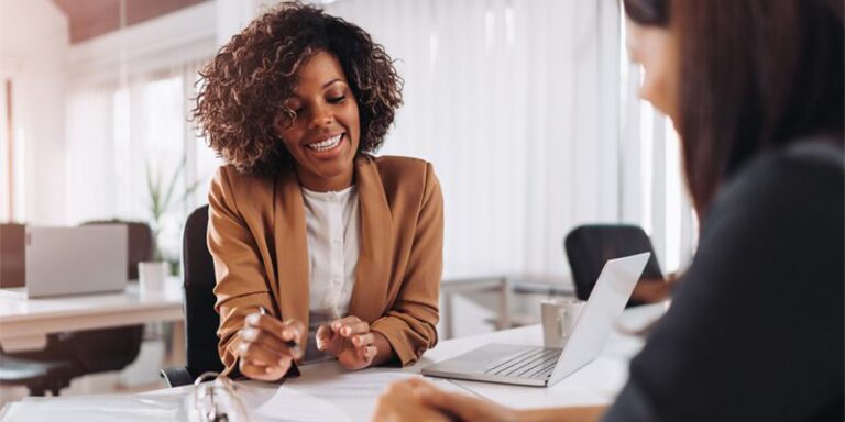 A businesswoman smiling and going over documents.