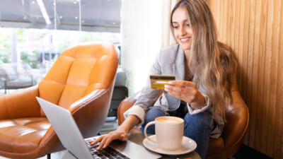 A young woman shopping online with her credit card.