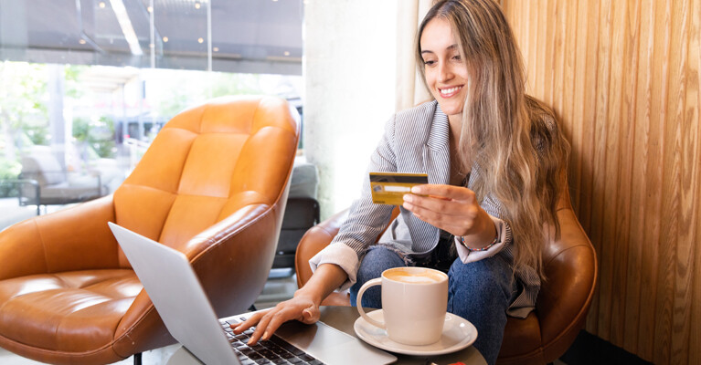 A young woman shopping online with her credit card.