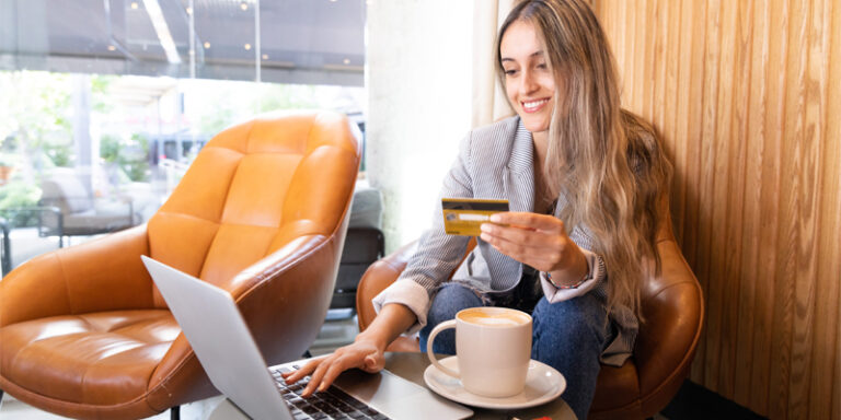 A young woman shopping online with her credit card.