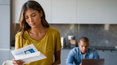 A couple reviewing financial mail.