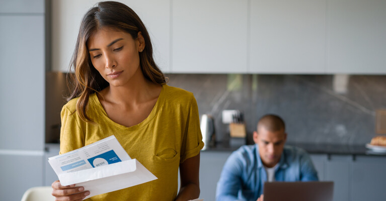 A couple reviewing financial mail.