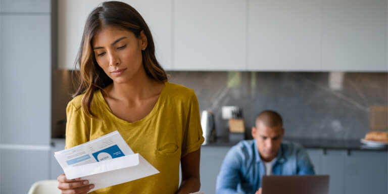 A couple reviewing financial mail.
