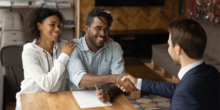 Man and woman shaking hands with businessman.