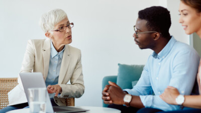 A couple discussing their finances with their advisor.