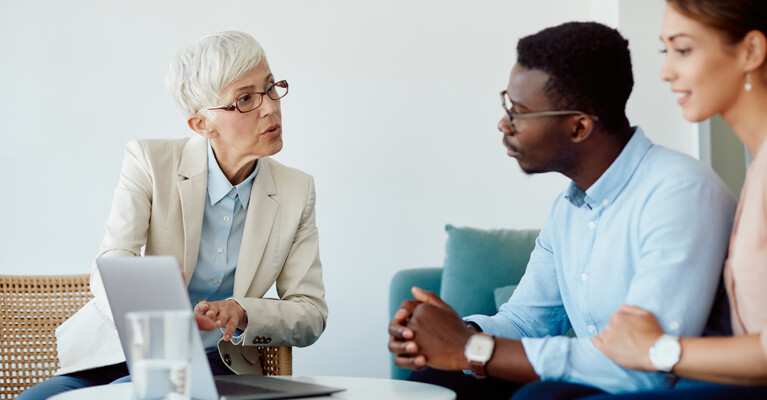 A couple discussing their finances with their advisor.