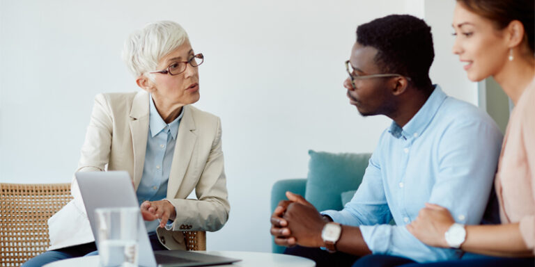 A couple discussing their finances with their advisor.