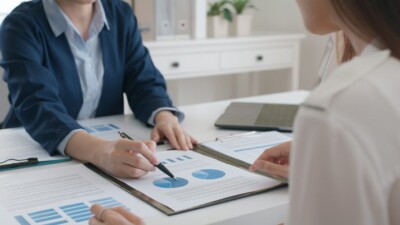 Two people examining a pie chart.