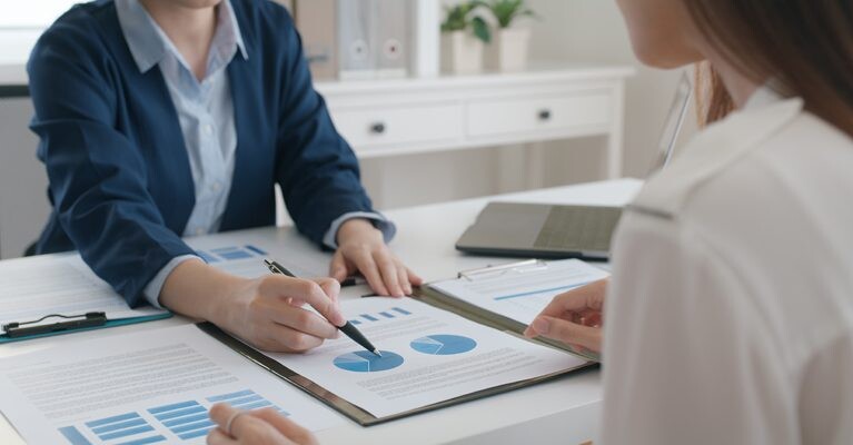 Two people examining a pie chart.